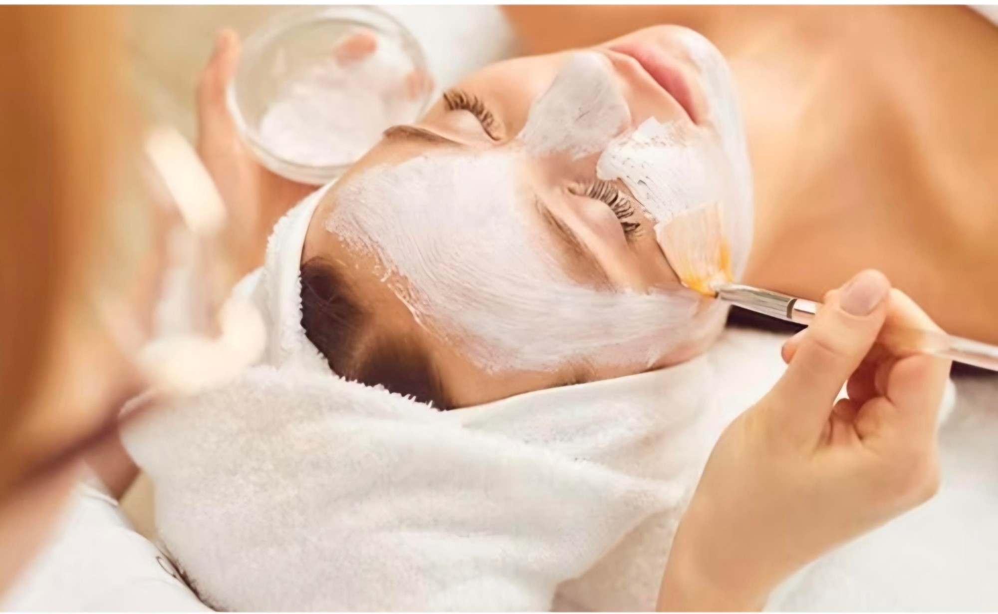 Face mask applied with a brush during a facial